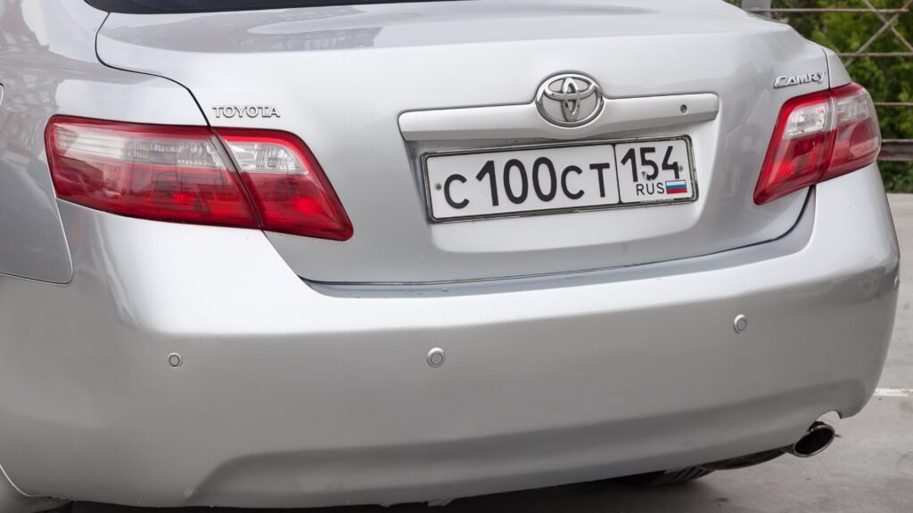 Rear view of a silver Toyota Camry showing the boot and badges
