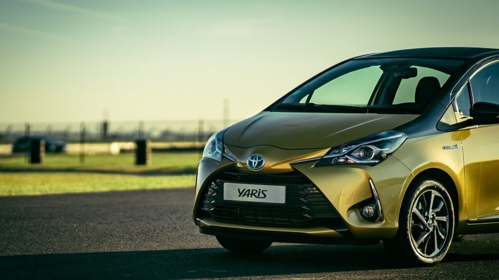 Gold Toyota Yaris Hybrid parked outdoors